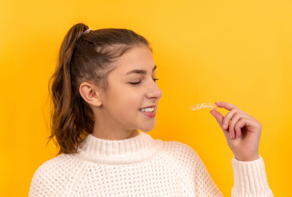 Clear aligner tray used for Invisalign treatment for teens